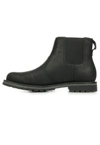 Zwarte leren enkelboot met elastische panelen aan de zijkanten, ronde neus en een getextureerde rubberen zool met gripgroeven.