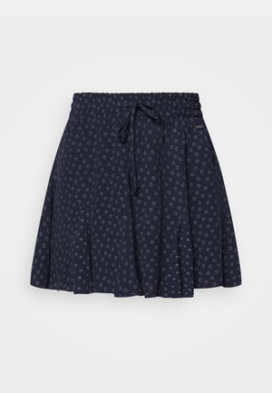 Navyblå nederdel med små hvide blomsterprint, elastisk talje og snoretræk foran.