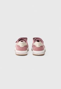 Pink suede shoes with beige accents, low-top design, hook-and-loop fastening, and white rubber sole with a brown bottom.