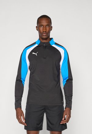 Schwarzes, langärmliges Sporthemd mit blauen und weißen Akzenten sowie einem Reißverschluss am Ausschnitt. Aus leichtem, feuchtigkeitsableitendem Material gefertigt.