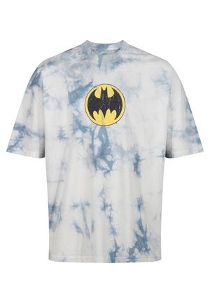 White T-shirt with blue tie-dye pattern. Features a yellow Batman logo centered on the chest. Crew neckline, short sleeves, relaxed fit.