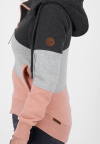 Felpa con cappuccio caratterizzata da una combinazione di sezioni grigio scuro, grigio chiaro e rosa; presenta una toppa in pelle marrone con il logo e tasche laterali.