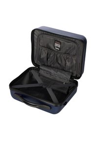 Valigia rigida blu con interni neri, dotata di tasche per il riposo e cinghie per fissare gli oggetti. Chiusura con cerniera, forma rettangolare.