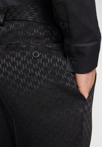KARL LAGERFELD TROUSERS COSMOS - Suit trousers - black