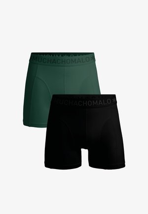 Zwei Paare Boxershorts: eines in dunkelgrün und eines in schwarz. Beide haben eine glatte Textur und einen elastischen Bund mit "MUCHACHOMALO"-Branding.