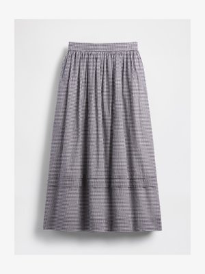 Rutete skjørt i svart og hvitt, med elastisk midje og rynket stoff. Designet har et flerlaget sømdetalj.