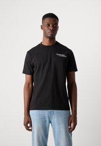 Black cotton t-shirt featuring short sleeves, round neckline, and white text reading "Espresso Awakening" on the left chest area.