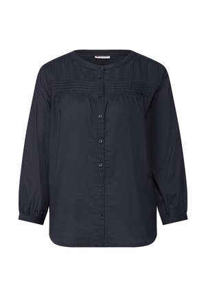 Chemise à manches longues bleu foncé avec un col rond, fermeture à bouton et détails froncés sur la partie supérieure. Fabriquée en tissu léger.