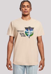 Beige cotton t-shirt featuring a graphic print of a man in a hat with landscapes, text reading "David Bowie" and "The Man Who Fell to Earth."
