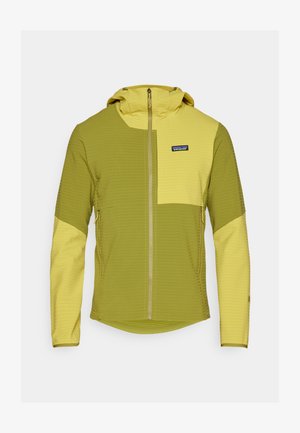 Kapucnis dzseki olívazöld és világos sárga panelek keverékével, teljes cipzárral és textúrázott anyaggal. Patagonia logóval a mellrészen.