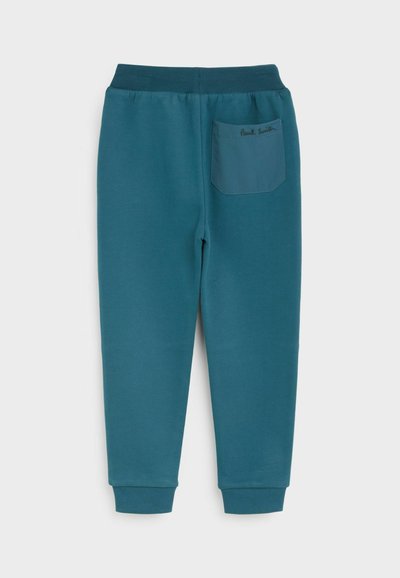 Teal tepláky s ribovaným pásom a manžetami. Majú jednu nášivkovú vrecko na zadnej strane, s nápisom "Paul Smith" vyšitou nad ním.