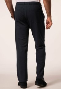 Navy blue textured trousers with a relaxed fit, featuring two back pockets and a waistband design for comfort.