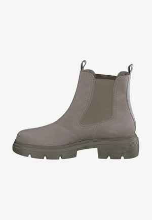 Stivaletto in suede beige con pannelli laterali elasticizzati, linguetta per infilare e suola in gomma spessa. Caratterizzato da una punta arrotondata e superficie testurizzata.