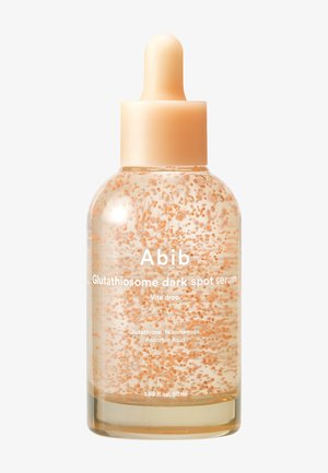 Flacon compte-gouttes transparent avec sérum couleur pêche contenant des billes en suspension, étiqueté "Abib Glutathiosome serum anti-taches" pour le traitement de la peau.
