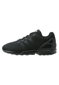 Black athletic shoes with a textile upper, three black stripes, lace-up closure, and a rubber sole featuring a distinct angular design.