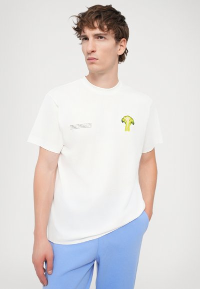White cotton T-shirt with short sleeves, featuring a small green broccoli graphic and black text on the left side, round neckline.