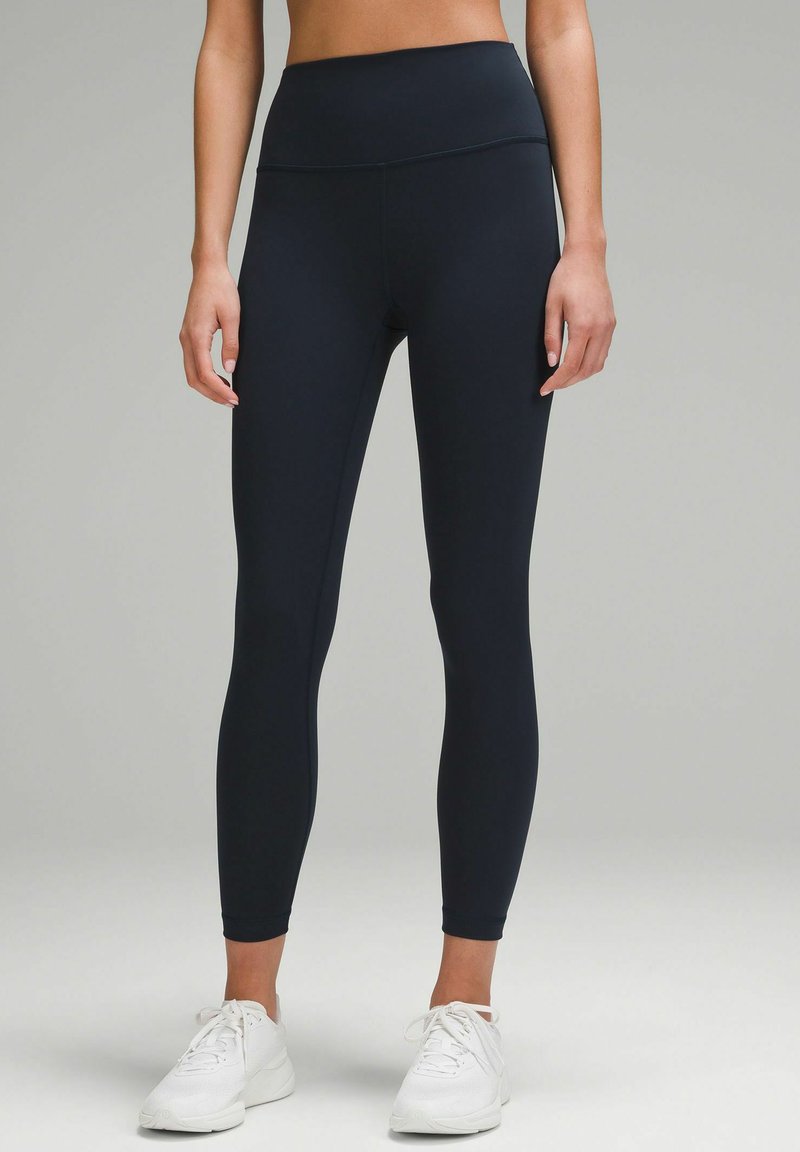 High-waisted, form-fitting leggings in dark navy, made from stretchy fabric. Features a smooth texture and no visible patterns or accents.