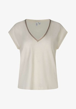 Haut crème à manches courtes avec col en V et bordure métallique autour du col, coupe ample et texture de tissu douce.