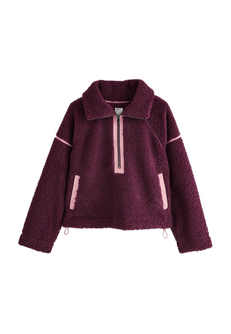 Sweatshirt din fleece mov cu guler cu fermoar, accente roz contrastante, două buzunare laterale și material texturat. Design scurt cu tiv elastic.