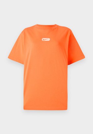 Oranje katoenen t-shirt met een ronde hals en korte mouwen. Bevat een klein wit Nike-logo op de borst. Casual fit en een gladde textuur.