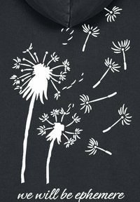 Felpa nera con grafiche di tarassaco bianche e il testo "noi saremo effimeri". Il design include dettagliati modelli di tarassaco e semi.