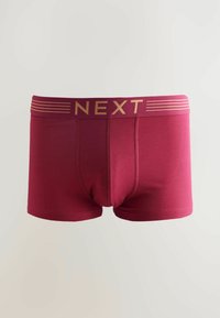 Boxer rouge bordeaux avec une texture lisse, présentant une large ceinture avec le logo "NEXT" en or et des rayures horizontales.