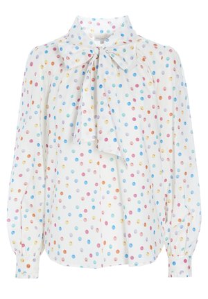 Blouse blanche à pois colorés, manches longues bouffantes, poignets boutonnés et grand nœud noué au col.