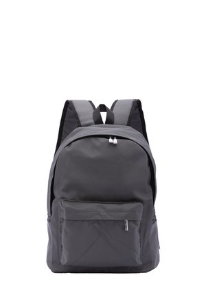 Gray fabric backpack with a rounded shape, dual zipper closure, front pocket, and adjustable black straps. Minimalist design with no patterns.