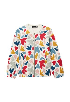 Veste matelassée blanche avec fermeture éclair à l'avant et motifs colorés de cœurs et feuilles abstraites en rouge, bleu, jaune, gris et rose.