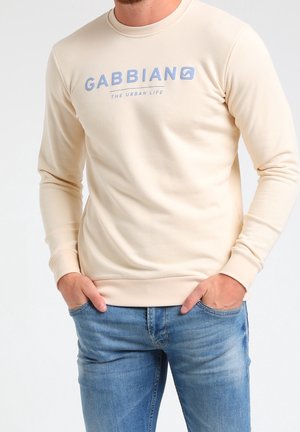 Sudadera de manga larga en beige claro con un logo de texto azul "GABBIANO THE URBAN LIFE". Textura suave con puños y cinturilla de canalé.
