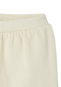 Cremefarbener Strickstoff mit einem gerippten elastischen Bund, der unterhalb des Bundes eine geraffte Detail zeigt.