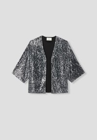 Veste ornée de sequins en argent et noir, présentant une coupe ample, un col en V et de larges manches pour une silhouette décontractée.