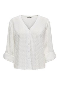 Biała bluzka z dekoltem w kształcie litery V i rolowanymi rękawami, z podniesioną fakturą w kropki i zapięciem na guziki z przodu. Miękka tkanina o luźnym kroju.
