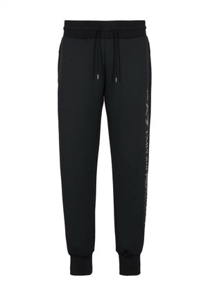 Pantaloni jogger neri realizzati in tessuto morbido, con vita elastica e cordino, gambe affusolate e un dettaglio logo lungo il lato.