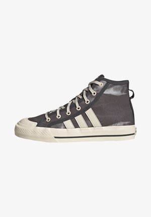High-top sneakers in dark gray fabric with beige accents, featuring six eyelets, three white stripes on the side, and a rubber toe cap.