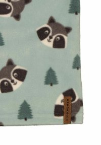 Fleece-tyg i ljusblått med rävvakters ansikten och gröna trä-mönster. Inkluderar en brun etikett med "Geggamoja"-logo i botten.