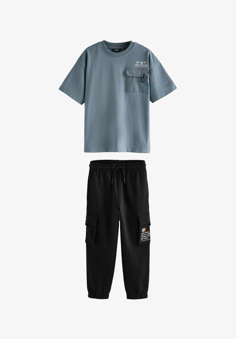 Gray cotton t-shirt with short sleeves and a chest pocket. Black sweatpants with elastic waistband and cargo pockets.