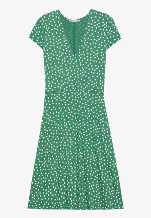 Green dress with short sleeves, V-neck, white polka dots, pleated skirt, and a mid-length design. Soft fabric texture noted.
