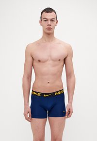 Nike Underwear TRUNK 3 PACK - Calzoncillos - uni gold/dark grey/blue void