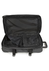 Valigia di tessuto grigia con un ampio interno, foderata in nero, scomparti con zip e doppi manici per un facile trasporto.