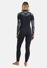 Black wetsuit with floral-patterned long sleeves, smooth texture, fitted design, and ankle-length legs, showcasing a high neck and back detailing.