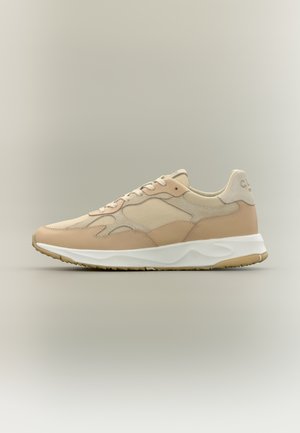 Beige and tan sneaker with mesh and suede panels, white cushioned sole, and lace-up design, displayed against a neutral background.