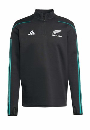 Sort atletisk pullover med kvart lynlås, turkise striber på ærmerne og "All Blacks" logoet tydeligt vist på brystet.
