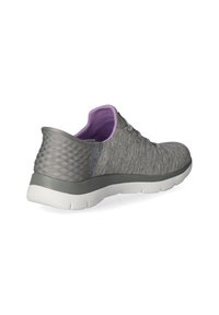 Grijze sportschoenen met een gestructureerde stoffen bovenkant, paarse binnenvoering, flexibele zool en een geometrisch patroon op de hiel.