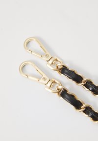 Black leather strap with gold metal clasps featuring a chain design. Smooth texture with shiny gold accents and secure closure mechanism.