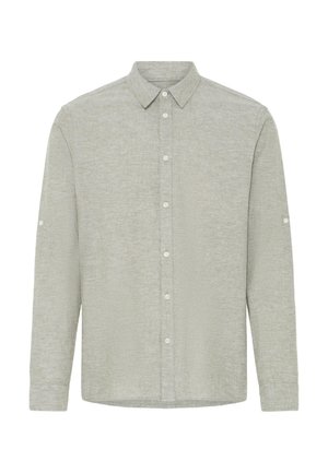 Vaaleanharmaa pitkähihainen nappipaita, jossa on terävä kaulus ja edessä sekä hihansuiden kohdalla napit.