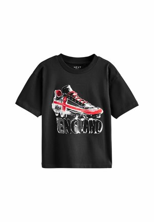Black short-sleeve T-shirt with a graphic of a soccer cleat featuring a red cross and the word "ENGLAND" below it.