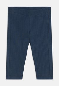 Leggings a coste di un blu navy realizzati in morbido tessuto a maglia. Caratterizzati da un elastico in vita e gamba tapered con orlo cucito.