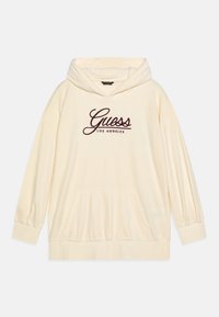 Sudadera con capucha de color crema, hecha de tejido acanalado. Cuenta con un bolsillo delantero y un logo bordado de "Guess Los Angeles" en burdeos.