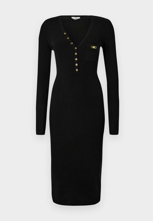 Black ribbed dress with long sleeves, V-neckline, gold accent buttons, and a small patch pocket on the chest, textured fabric.